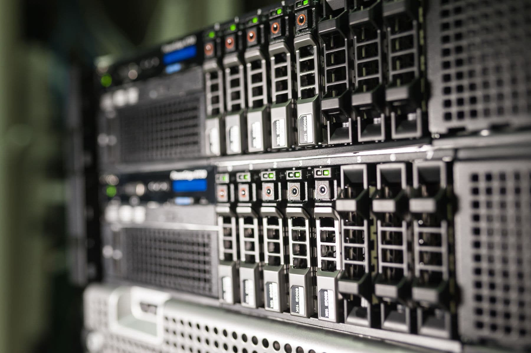 Stack of rack servers with drive sleds and network cards installed.
