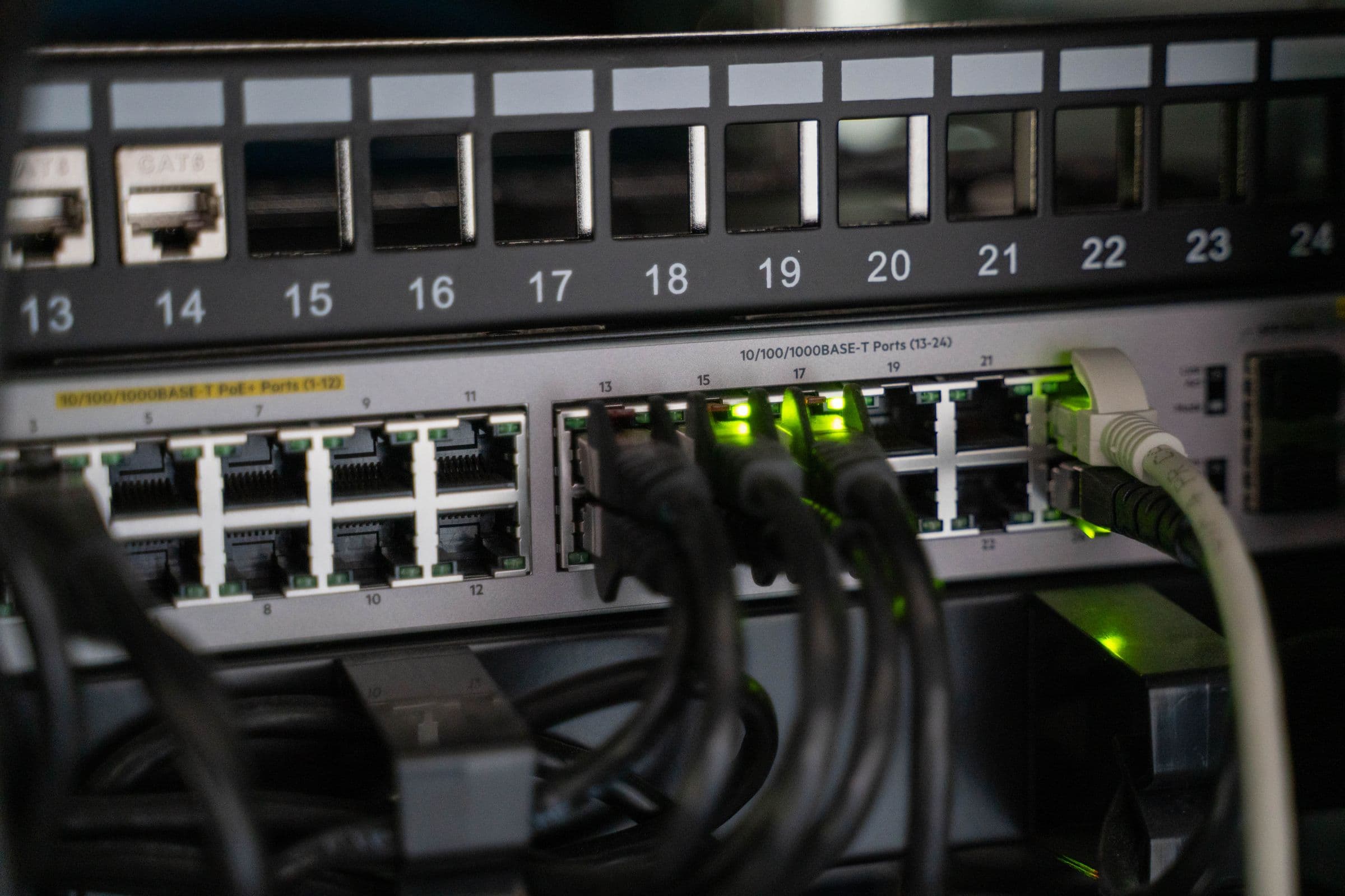 Patch panel and network switch ports with cables connected.